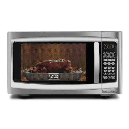 Photo of BLACK+DECKER MZ42PGSA microwave oven, front view, with cooked food inside and digital control panel.