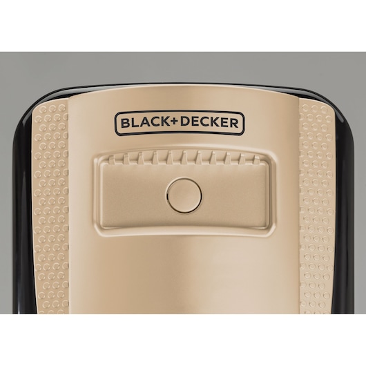 Photo of BLACK+DECKER OR011FD appliance top in gold with central button and textured side grips, front angle.