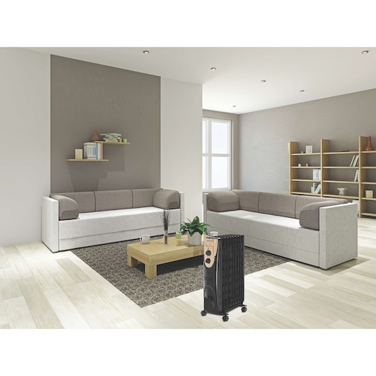 BLACKDECKER OR090D oil-filled radiator heater in a modern living room with gray sofas and wooden coffee table.