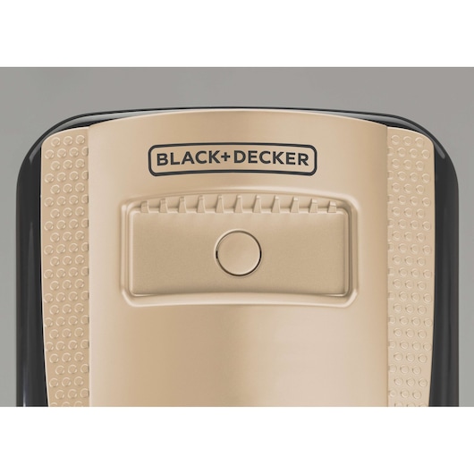 Photo of BLACK+DECKER OR090D beige and black electronic device top view with textured grip sides and central button.