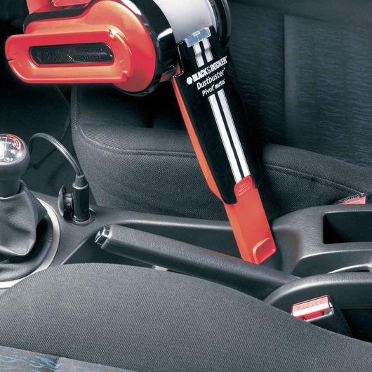 BLACKDECKER PAV1205 handheld car vacuum cleaning between car seats, close-up photo.
