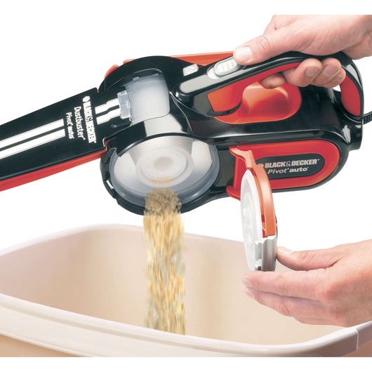 BLACKDECKER PAV1205 handheld vacuum being emptied over a bin, close-up view.