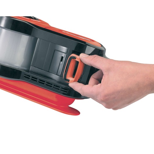 BLACKDECKER PAV1205 handheld vacuum cleaner close-up, hand opening dust compartment latch, side view.