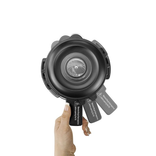 BLACKDECKER PB120 circular black vacuum filter held by a hand, white background, top view.