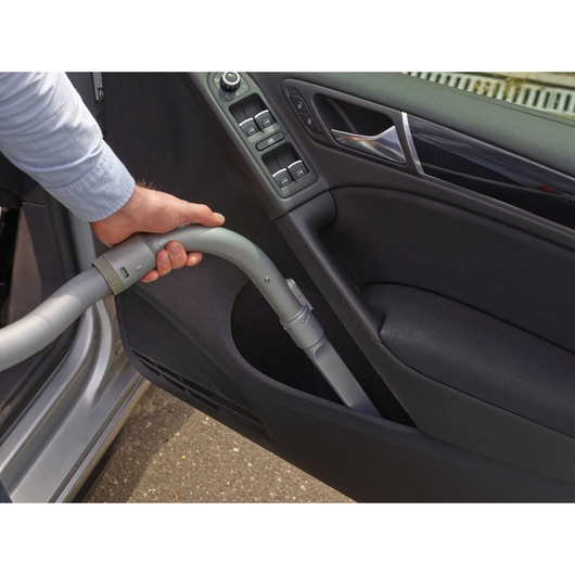 BLACKDECKER PD1200AV car vacuum hose cleaning door panel, close-up photography.