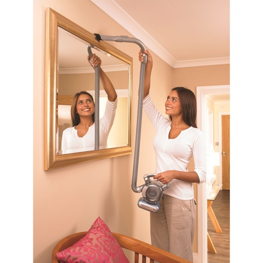 BLACKDECKER PD1420LP handheld vacuum cleaner with long hose cleaning mirror frame in home setting