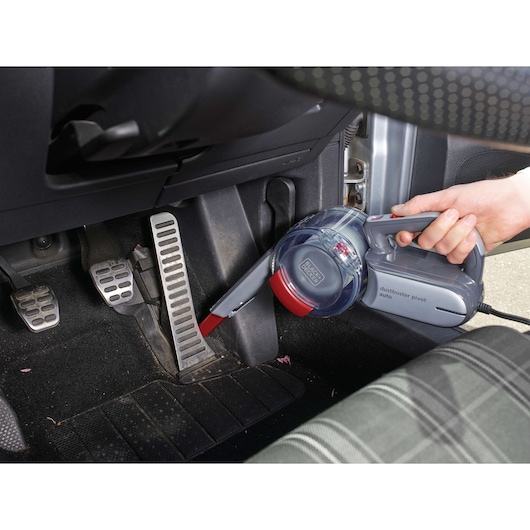 BLACK+DECKER PV1200AV handheld car vacuum cleaning car pedals and floor area.