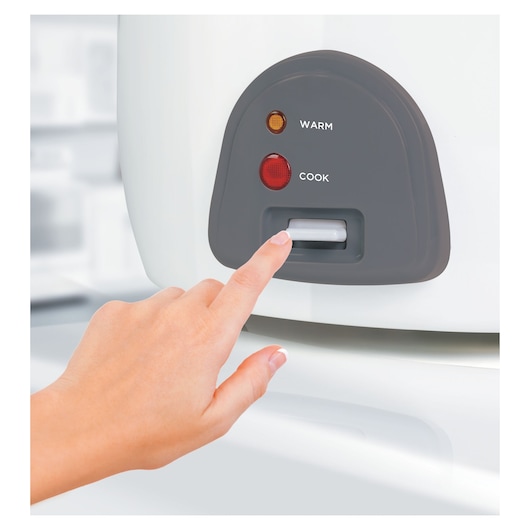 BLACKDECKER RC4500 rice cooker control panel close-up with hand pressing cook button.