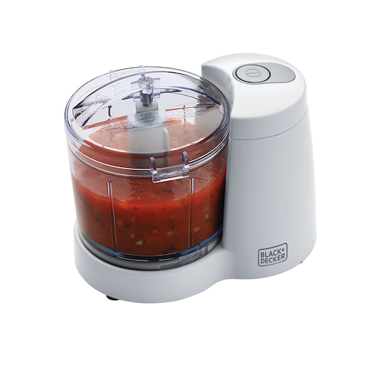 Photo of BLACK+DECKER SC350 mini food processor with clear bowl and red salsa, side angle.