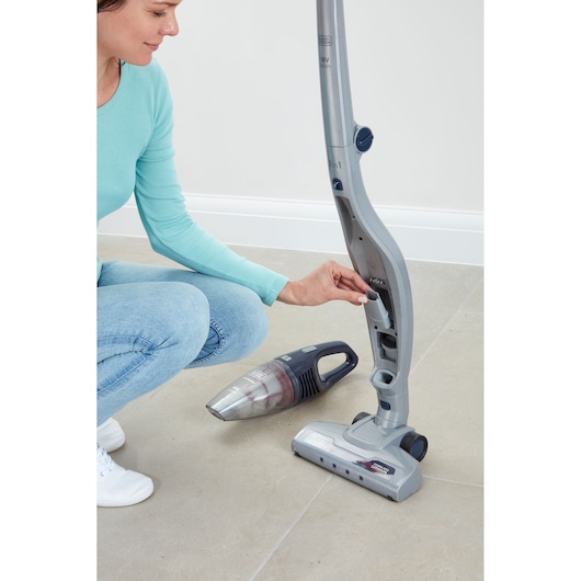 BLACK+DECKER SVB520JW cordless 2-in-1 stick vacuum cleaner with handheld unit, side view, on tile floor.
