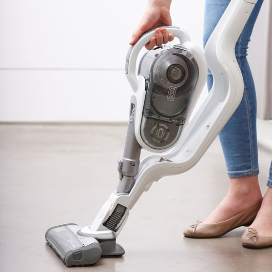 Photo of BLACKDECKER SVFV3250L cordless stick vacuum cleaner in use on light brown floor.