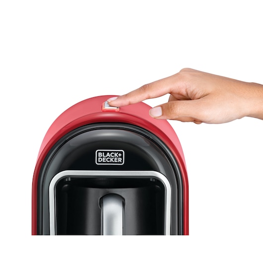 Photo of BLACKDECKER TCM700 coffee maker with hand pressing power button, front angle.
