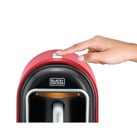 BLACKDECKER TCM700 coffee maker, red top view, hand pressing power button.