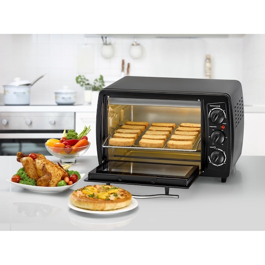 BLACKDECKER TRO19RDG toaster oven with toast slices, black, photographed on kitchen countertop.