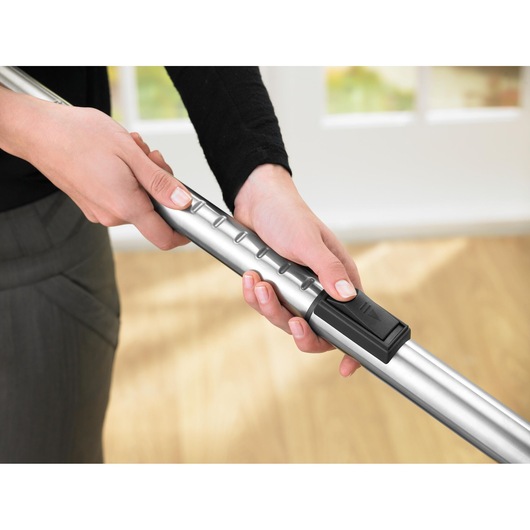 BLACKDECKER VM2825 vacuum cleaner metal extension wand with hand adjusting telescopic length indoors.