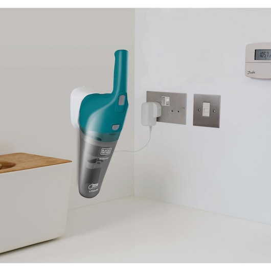 BLACKDECKER WDB215WA handheld vacuum charging on wall mount in modern kitchen.