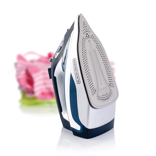 BLACKDECKER X2150 steam iron front angle, silver and blue, ceramic soleplate, with blurred folded laundry.