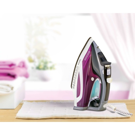 BLACKDECKER iron X2250 with purple and black design, upright on white cloth, front view.
