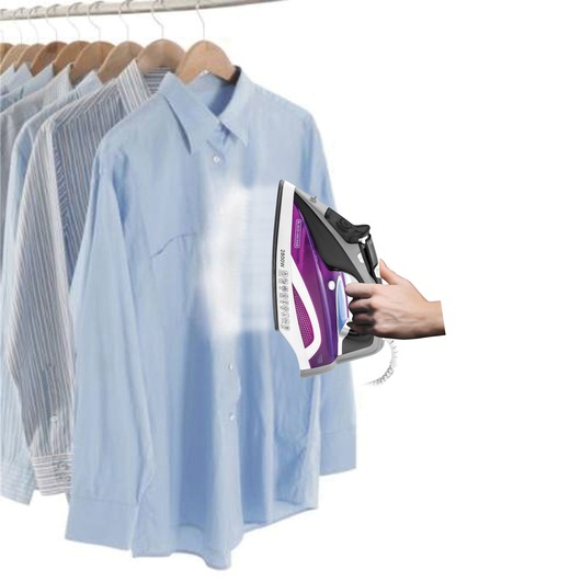 BLACKDECKER X2250 steam iron in use on blue shirt, clothing rack in background, side angle.