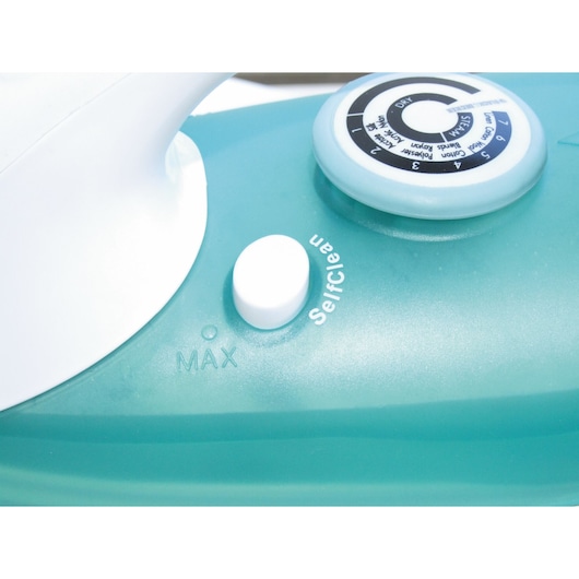 BLACKDECKER X810R steam iron close-up, showing control dial and self-clean button on turquoise body.